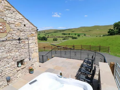 Cottage patio with hot tub and countryside views