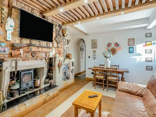 Living room with wood burner and dining table