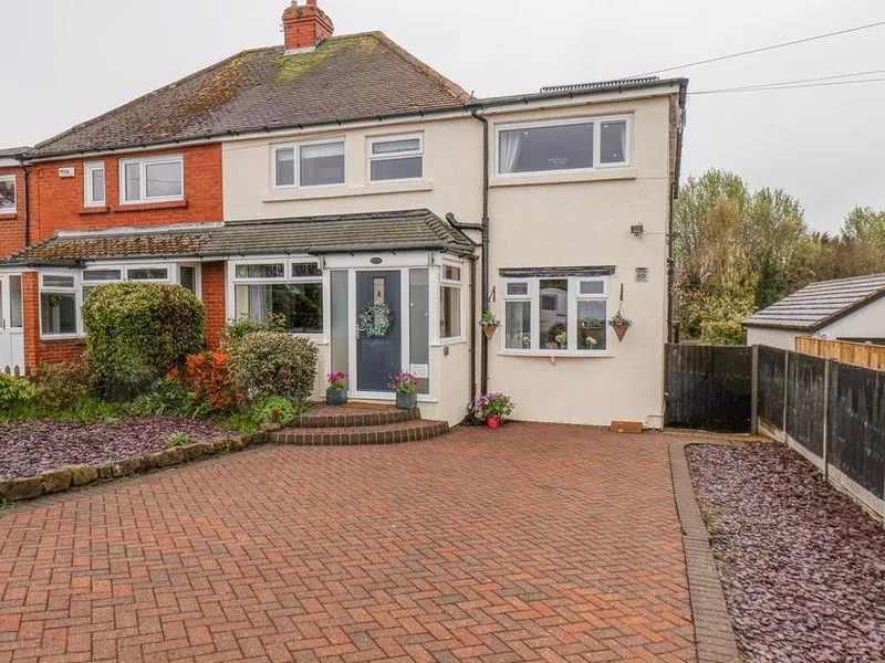 Castle View cottage with red brick and cream render, block-paved driveway, and front porch in Burniston