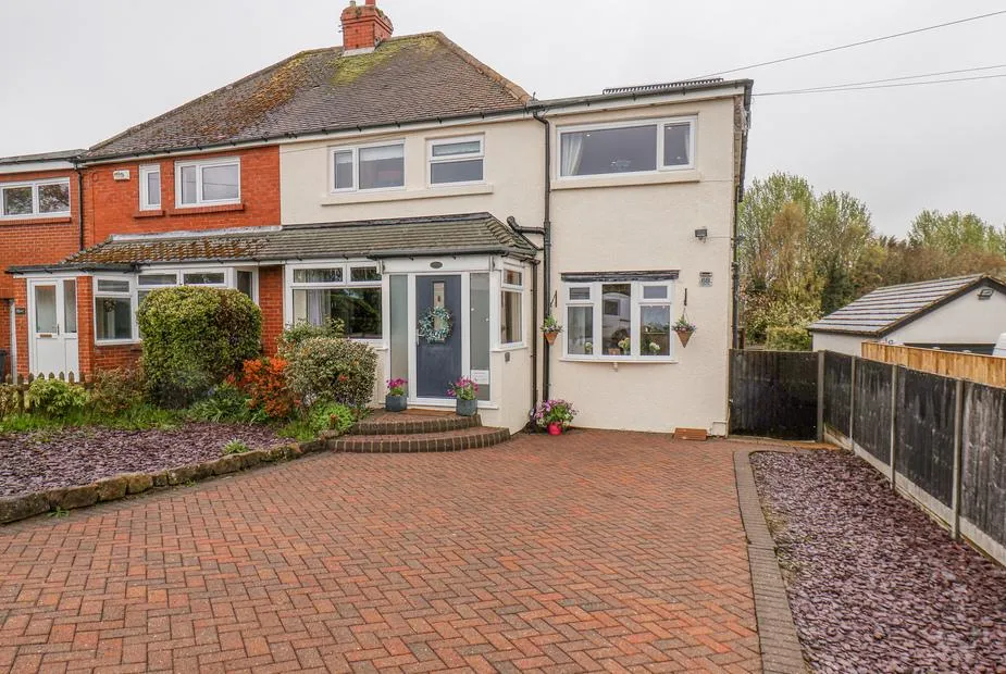 Castle View cottage with red brick and cream render, block-paved driveway, and front porch in Burniston