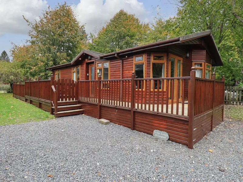 Cedar Lodge exterior with wraparound deck and surrounded by trees