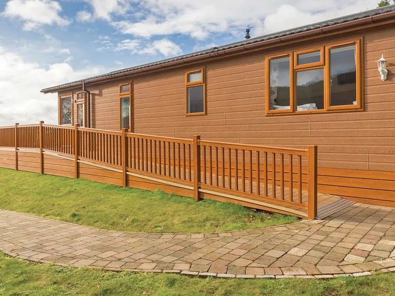 Cheddar Lodge Premier WF with ramped decking, wooden railings, and paved path