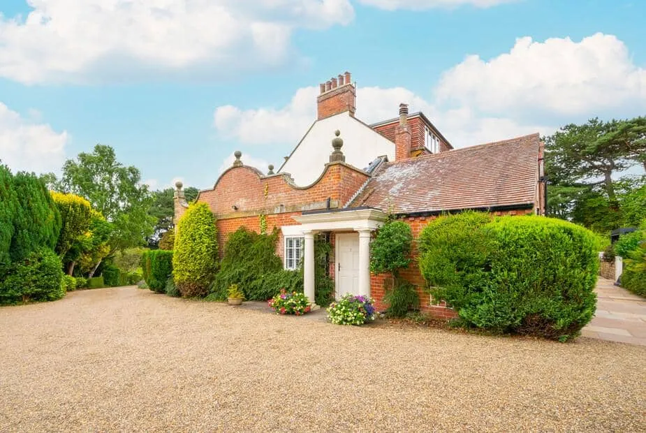 Church Beck House exterior with gravel driveway and surrounding greenery