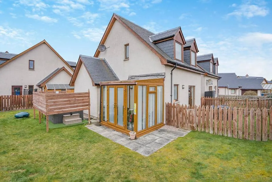 Clunnie Mor with sunroom and fenced garden on grass lawn