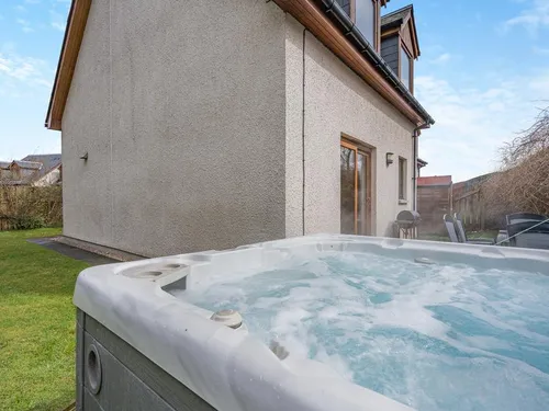 Cottage garden with outdoor hot tub and patio seating