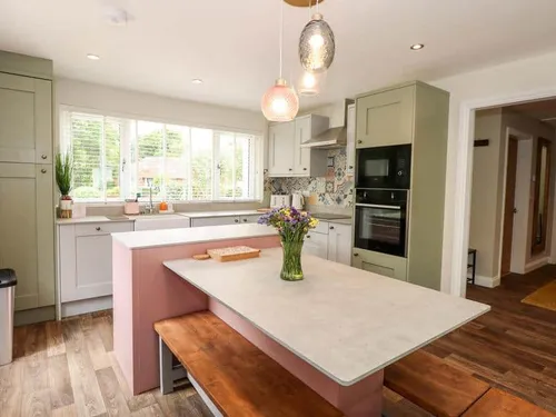 Kitchen with island, bench seating and built-in oven