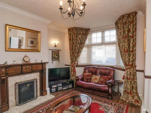 Cottage living room with ornate wood fireplace