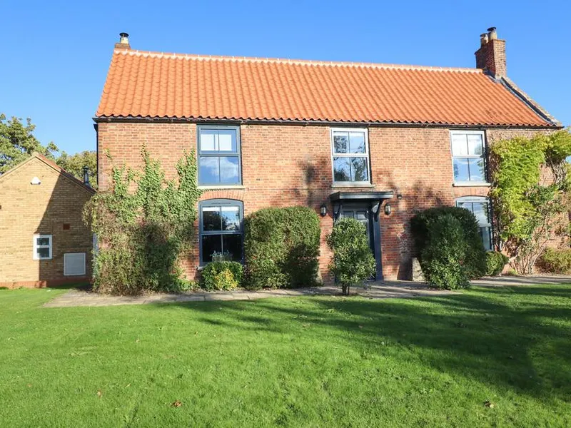 Hall Farm brick cottage with red tiled roof and large front lawn