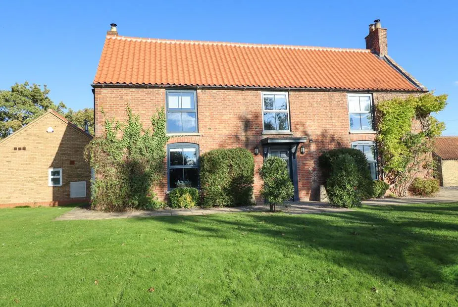 Hall Farm brick cottage with red tiled roof and large front lawn