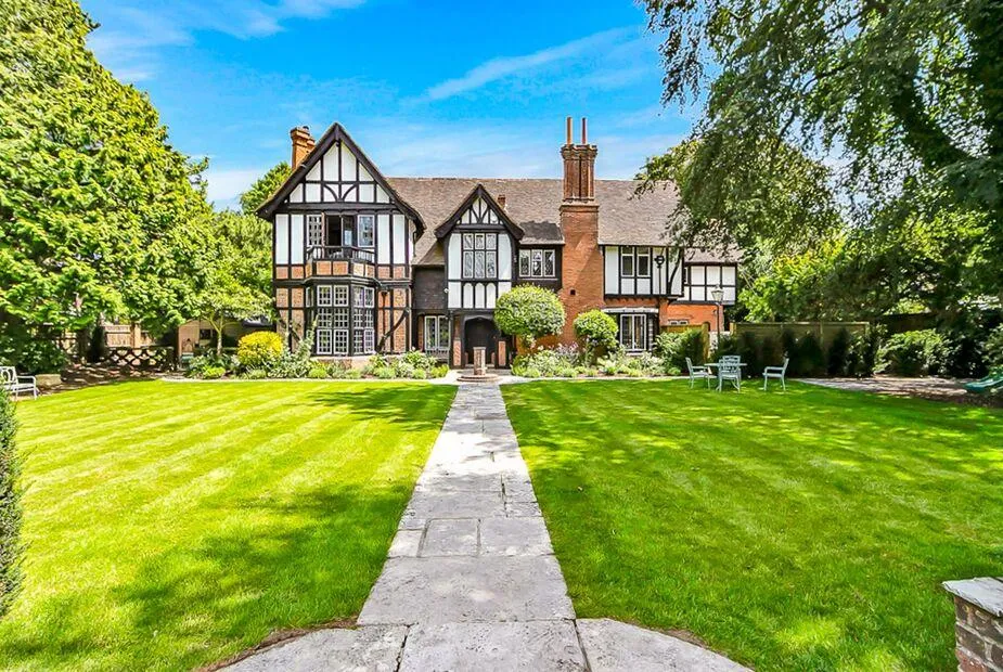 Highbury Mansion with extensive front lawn and stone path leading to entrance