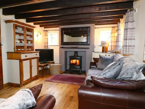 Lounge with wood-burning stove and leather sofas