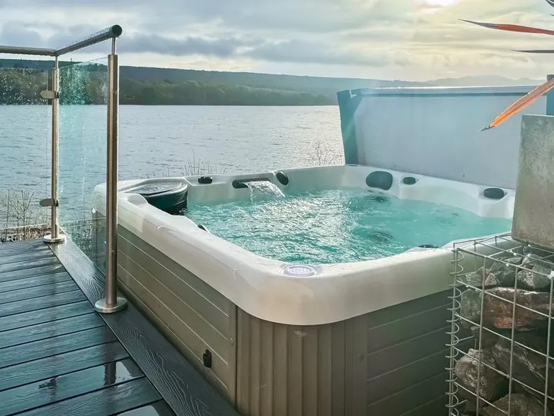 Hot tub on the deck with views straight across Loch Ness at sunset