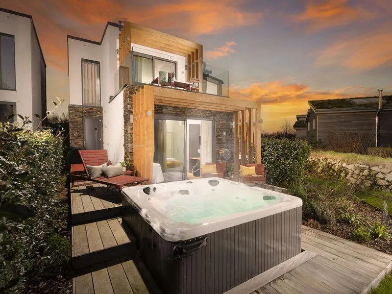 Lefransa lodge with outdoor hot tub and deck seating at sunset in Carbis Bay