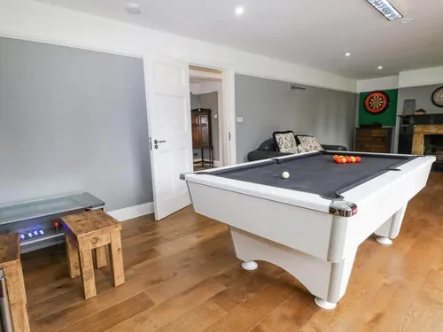 Games room in cottage with pool table and dartboard