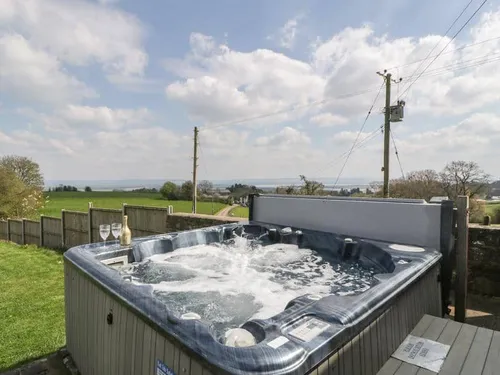 Hot tub in cottage garden with countryside view