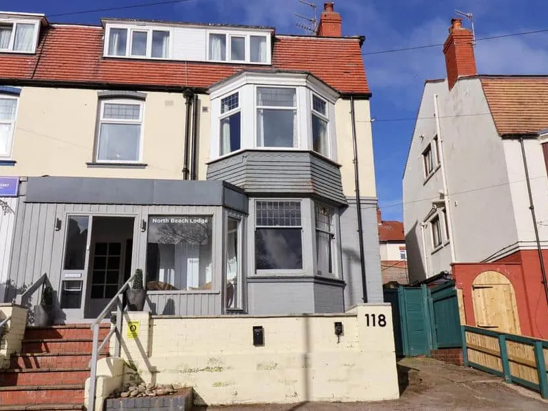 North Beach Lodge exterior with bay windows and front entrance steps