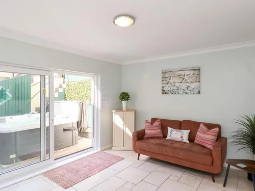 Lodge living area with sofa and sliding doors to hot tub patio