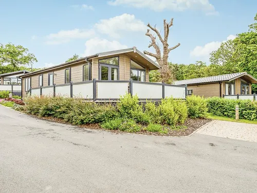 Lodge with wraparound decking and surrounding greenery