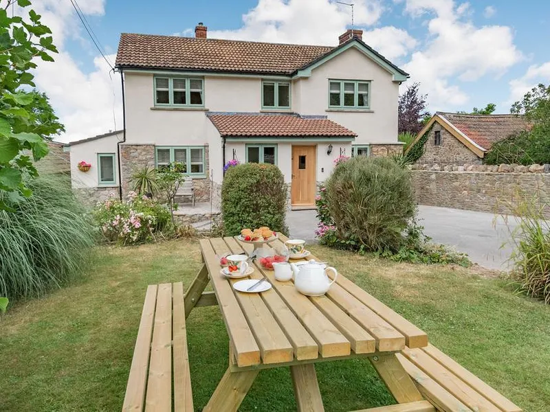 Pennyard House with picnic table and afternoon tea set in the front garden