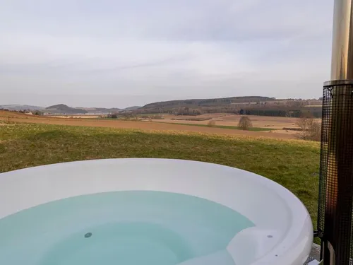 Hot tub with panoramic views across open farmland and distant Highland hills