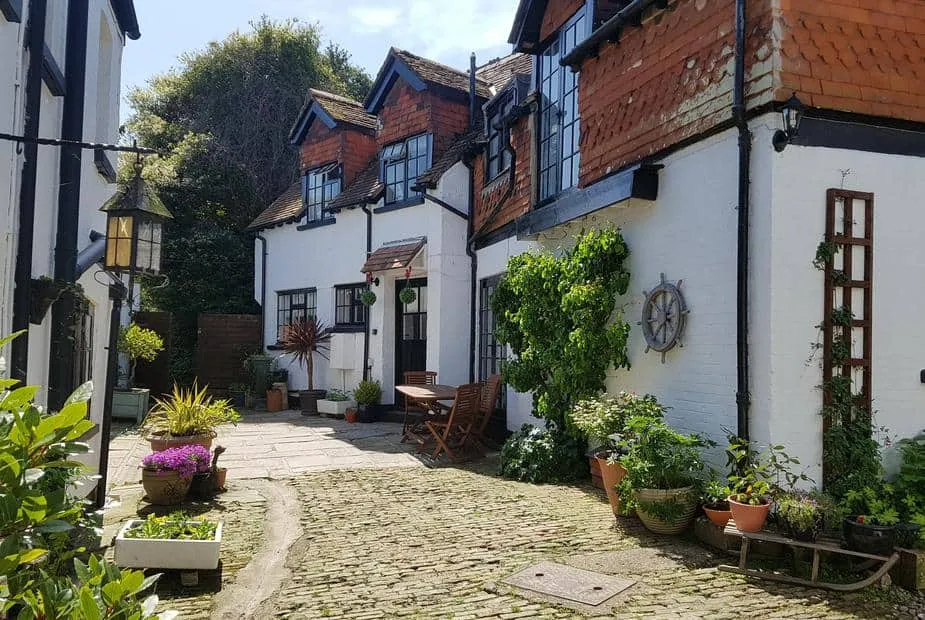 The Coach House exterior with cobbled courtyard and outdoor dining set.