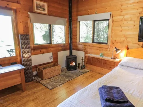 Bedroom with wood-burning stove and single bed