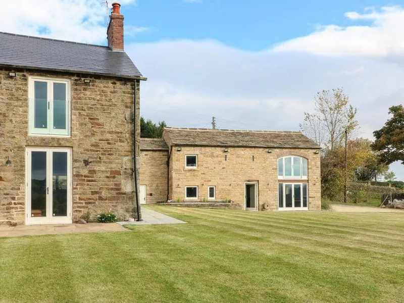 Top Hill Farm Cottage with large stone exterior and spacious lawn