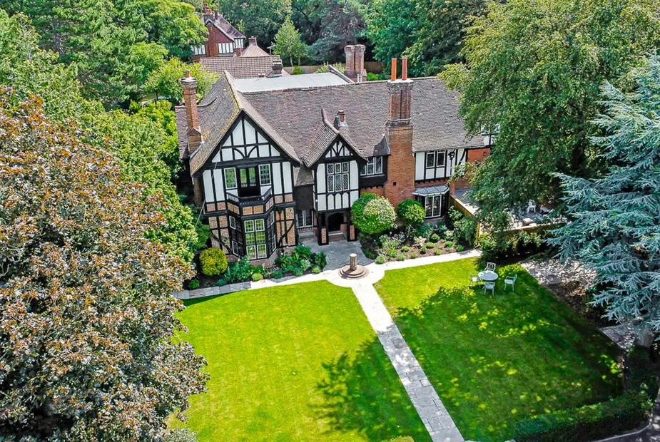 Tudor Grange with timber-framed exterior and large lawn garden with seating area