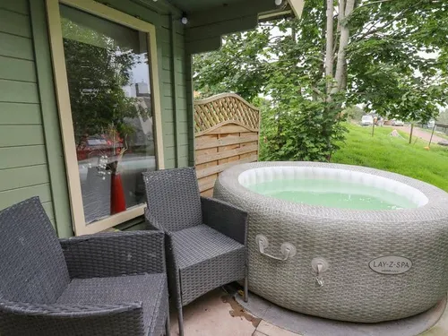 Lodge patio with rattan chairs and inflatable hot tub