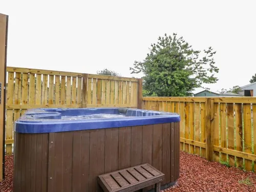 Cottage garden with hot tub and wooden fence