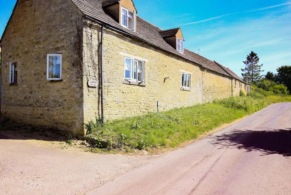 Washpool stone cottage exterior beside a quiet country road