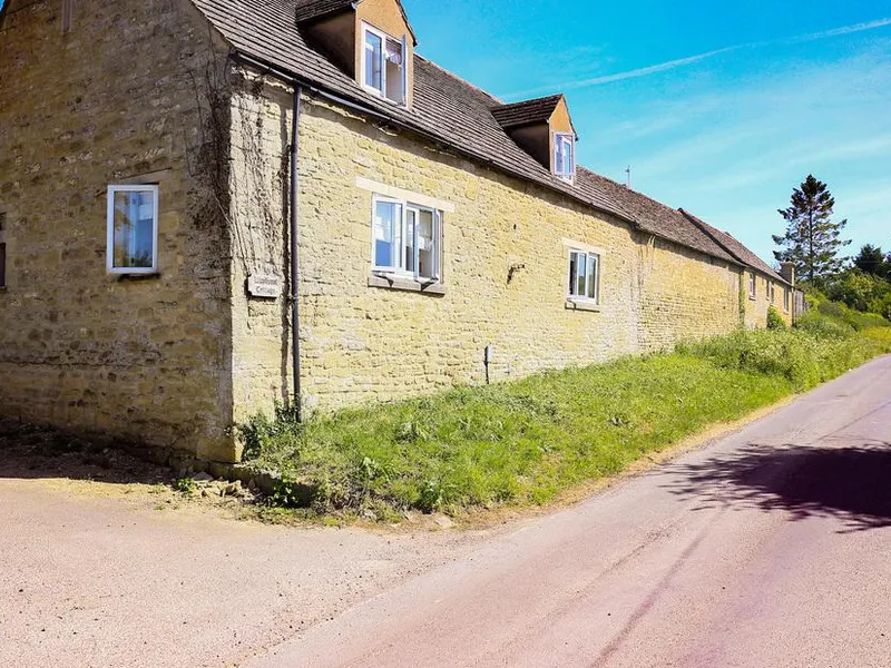 Washpool stone cottage exterior beside a quiet country road