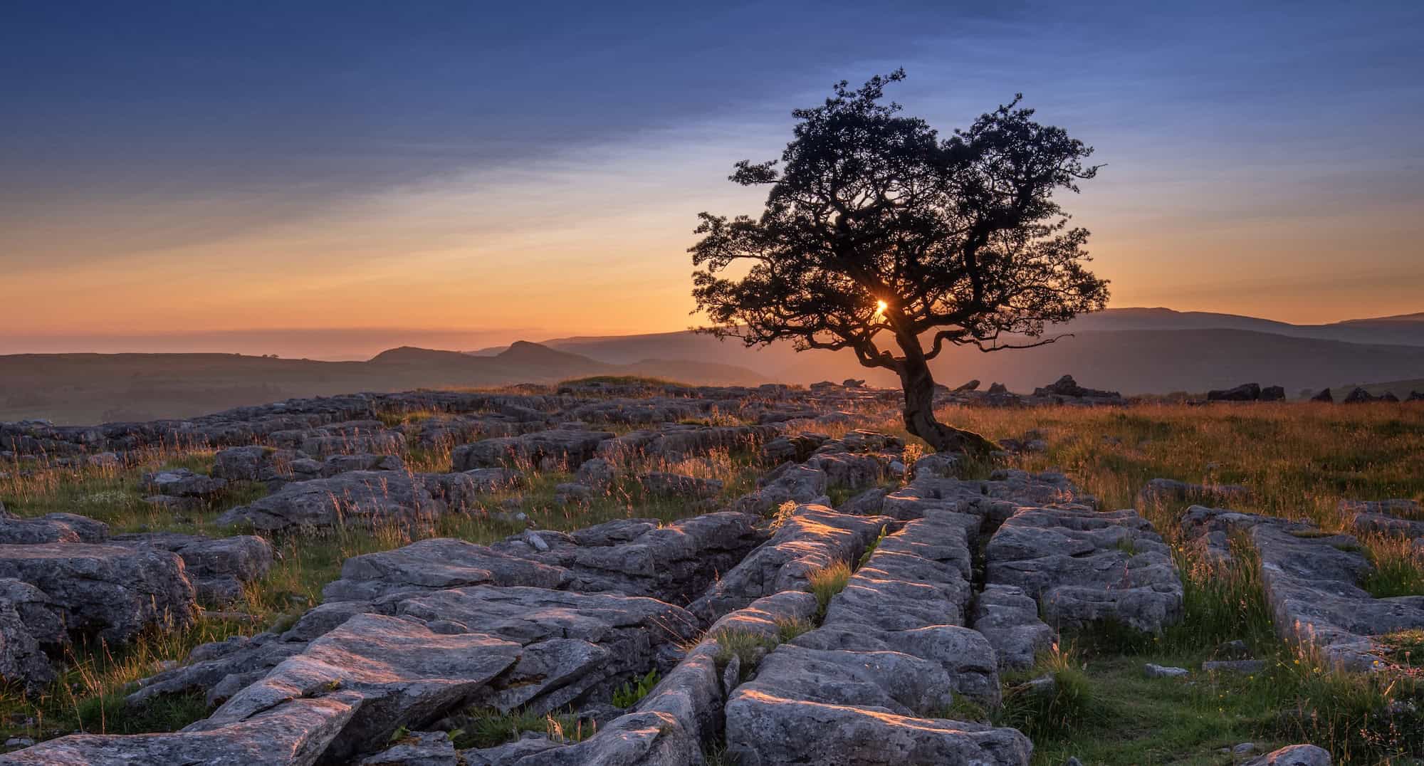 Golden sunset over limestone pavement at Winskill Stones in the Yorkshire Dales